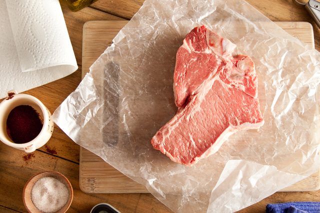 Steak cru avec du sel et assaisonnements secs.